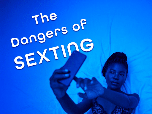 A person with dark skin and braided hair lies on a white, textured surface, holding a smartphone up to take a selfie. The scene is illuminated with a blue light. The text "The Dangers of SEXTING" is prominently displayed in white, sans-serif font in the upper left corner of the image.